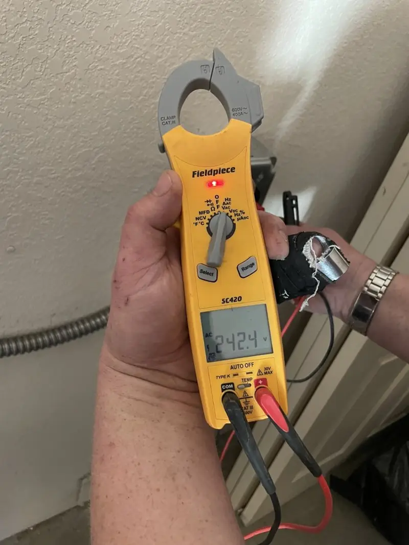 Voltage testing with clamp meter during Electrical Installation Services in Henrietta